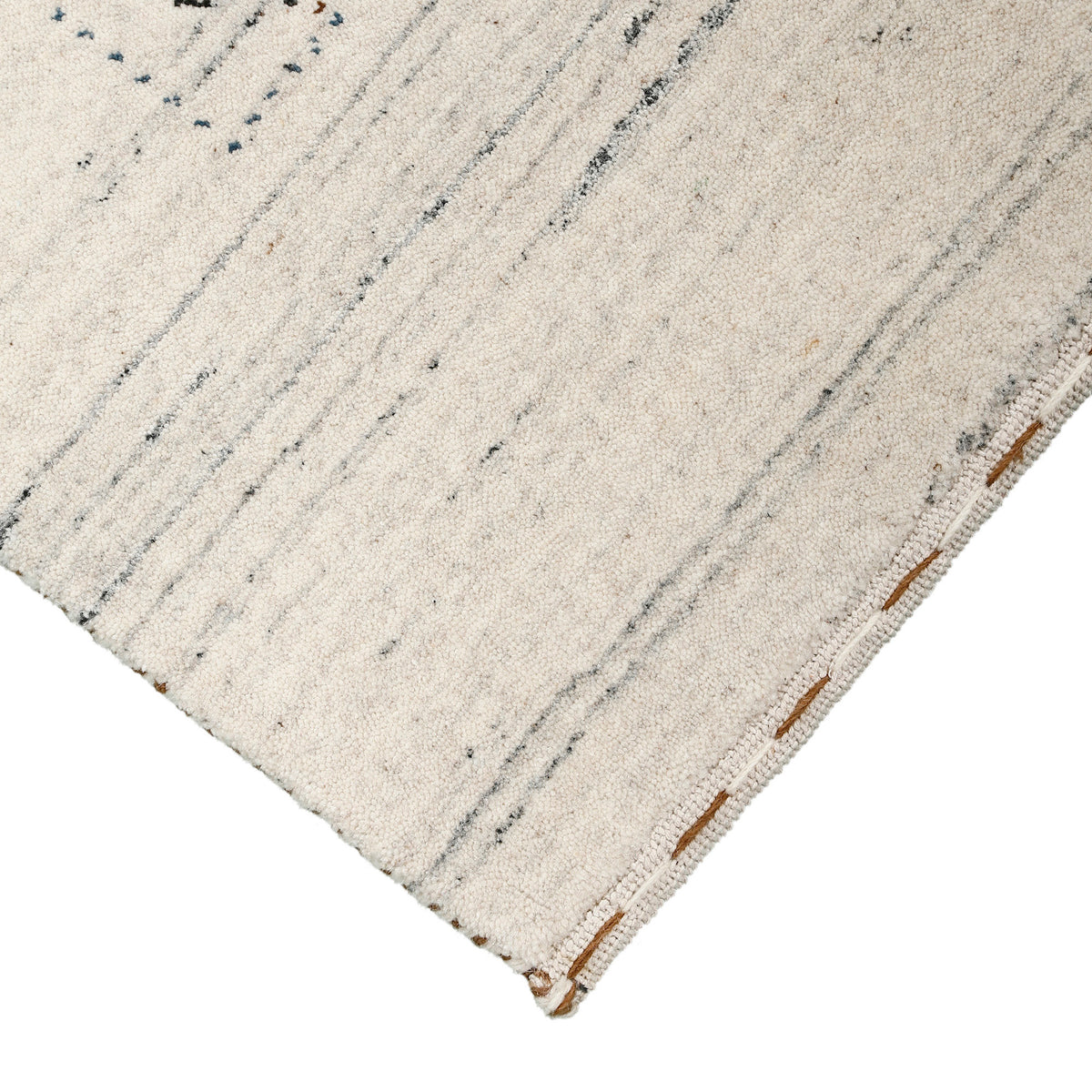 Corner and edge detail of ivory cream Hand Woven Loom Lori wool rug showing natural wool texture and handcrafted finishing