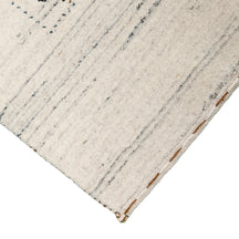 Corner and edge detail of ivory cream Hand Woven Loom Lori wool rug showing natural wool texture and handcrafted finishing