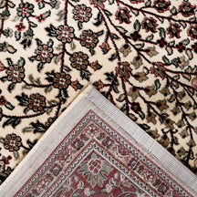 Corner and edge detail of Ivory Floral Medallion Machine Woven Classic Art Silk Rug with red ornamental border
