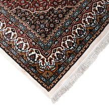Corner and fringed edge detail of Ivory Geometric Medallion Machine Woven Classic Art Silk Rug