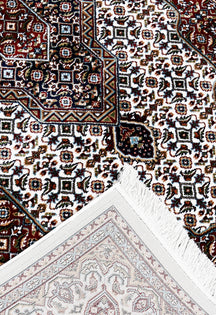Corner and fringed edge detail of Ivory Geometric Medallion Machine Woven Classic Art Silk Rug