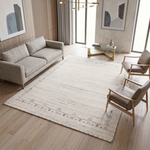 Ivory grey Hand Woven Loom Lori wool rug with minimal tribal border styled in an elegant neutral contemporary living room