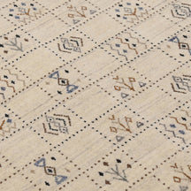 Close-up of ivory beige Hand Woven Loom Lori wool rug showing dotted grid panels, geometric symbols and natural wool texture