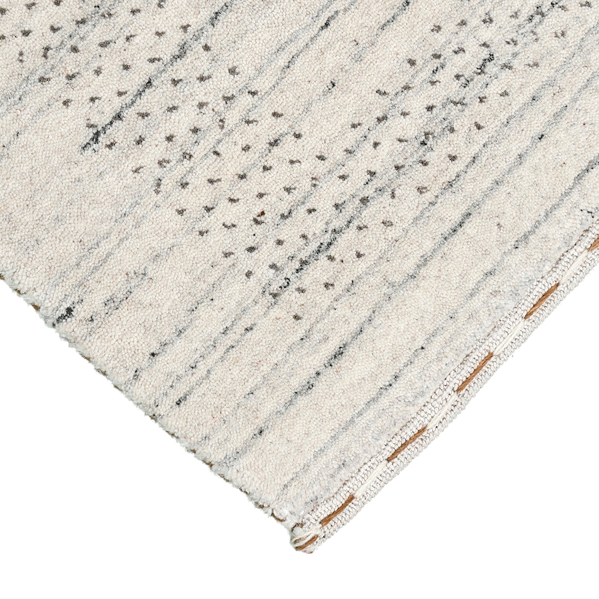 Corner and edge detail of ivory Hand Woven Loom Lori wool rug showing subtle geometric border and handcrafted finishing