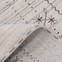 Corner and edge detail of ivory Hand Woven Loom Lori wool rug showing zigzag border and handcrafted finishing