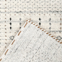 Corner and edge detail of ivory Hand Woven Loom Lori wool rug showing subtle geometric border and handcrafted finishing
