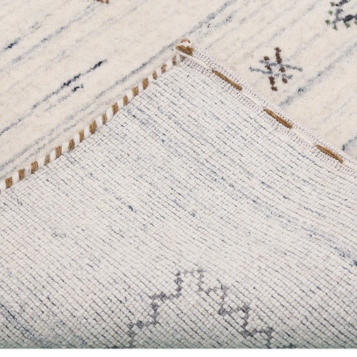 Corner and edge detail of ivory Hand Woven Loom Lori rug showing zigzag inner border and handcrafted finish