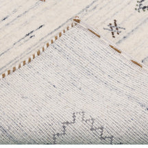 Corner and edge detail of ivory Hand Woven Loom Lori rug showing zigzag inner border and handcrafted finish