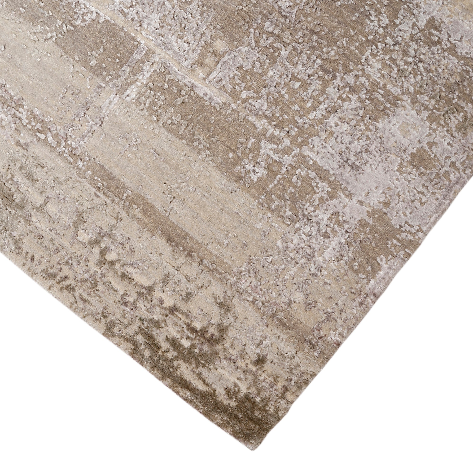 Hand-finished edge and softly distressed neutral surface of the Ivory Haze hand knotted modern rug
