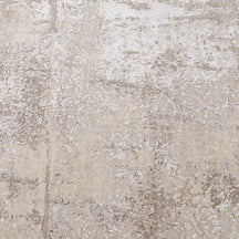 Close-up of the hand knotted wool and viscose texture with ivory beige greige and taupe abstract detailing