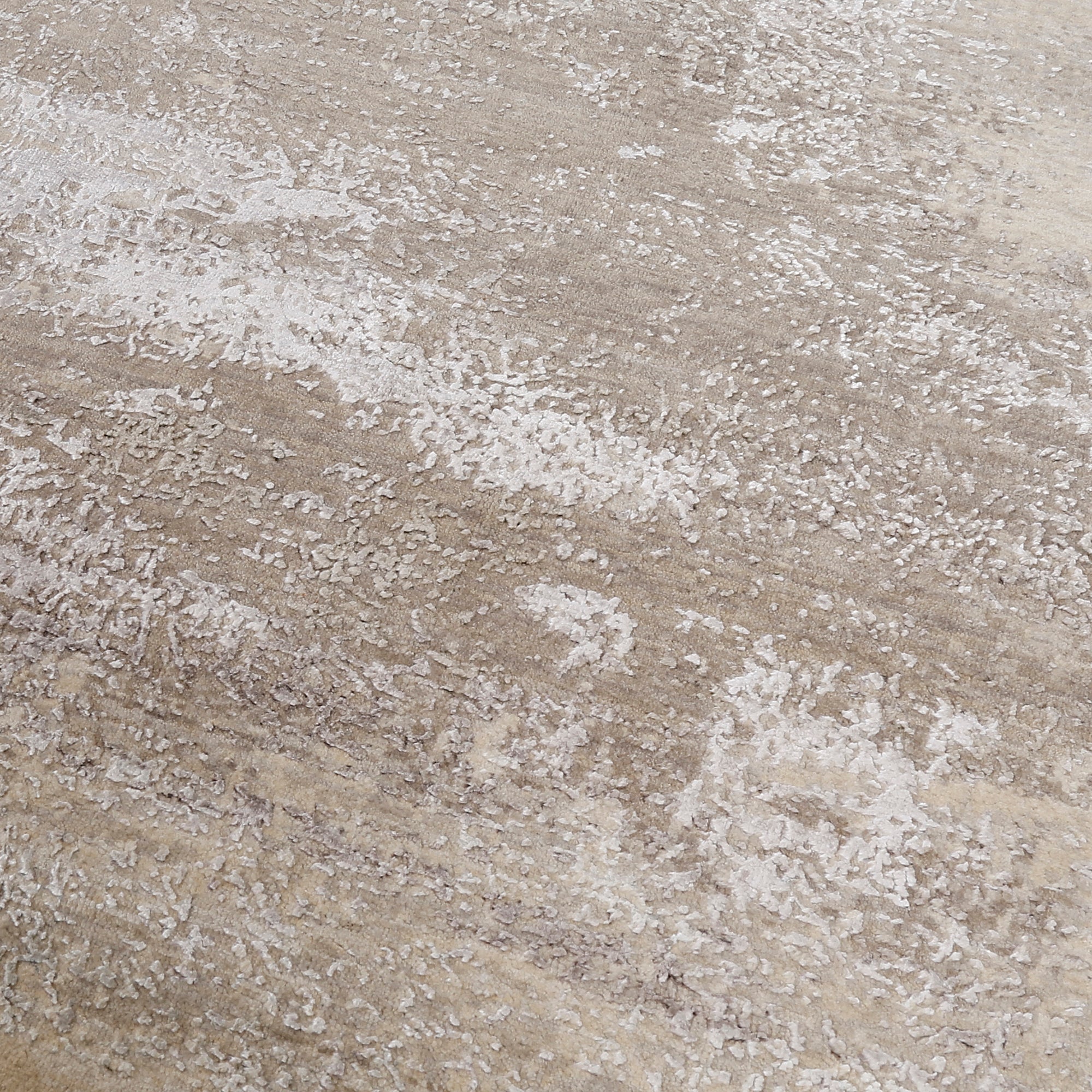 Close-up of the hand knotted wool and viscose texture with ivory beige greige and taupe abstract detailing