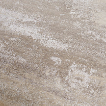Close-up of the hand knotted wool and viscose texture with ivory beige greige and taupe abstract detailing
