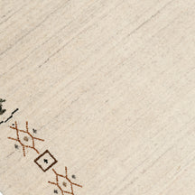 Close-up of ivory Hand Woven Loom Lori wool rug showing natural wool texture and detailed earthy tribal motifs