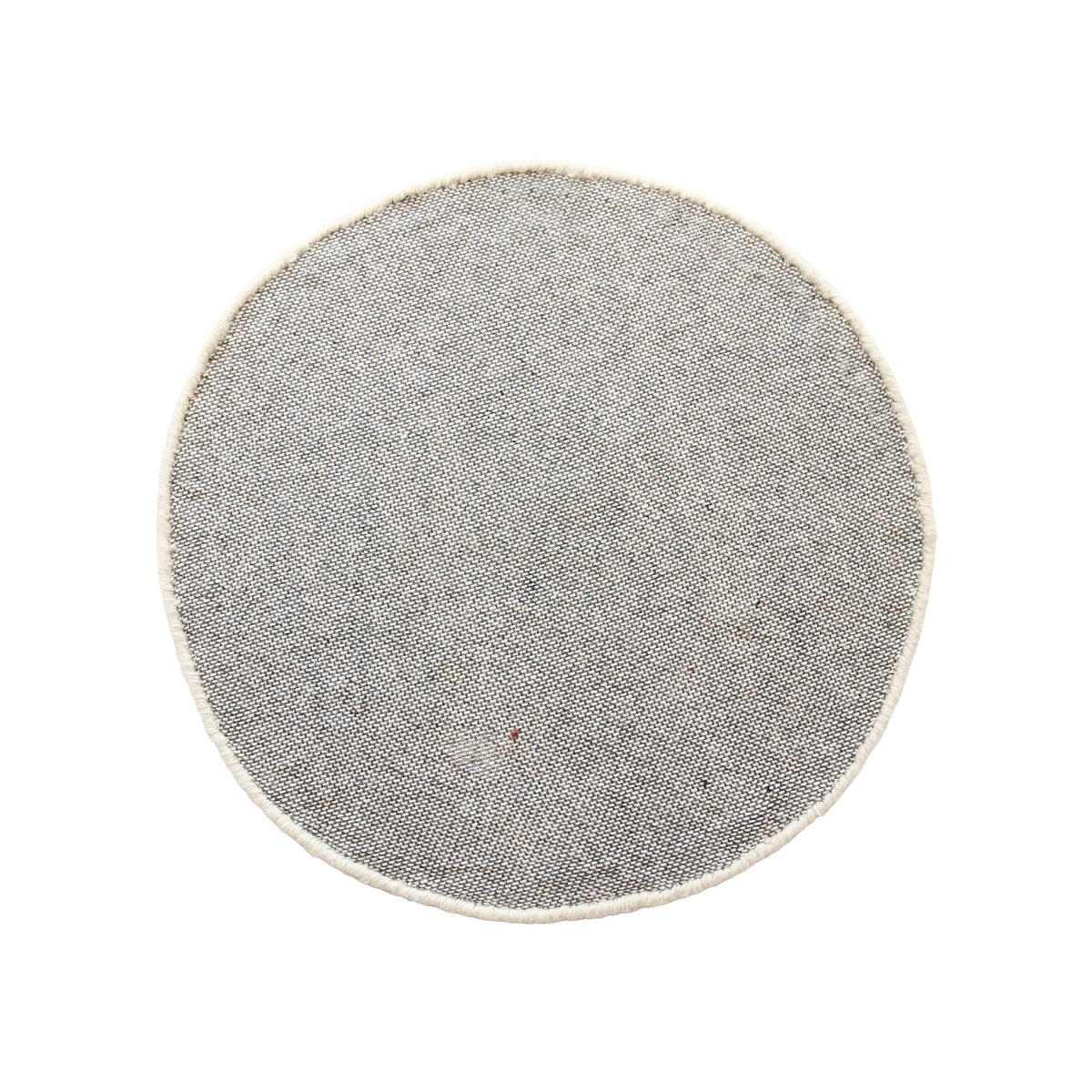 Side angle view of ivory smiley face wool kids rug showing its round shape, 12-15 mm hand tufted pile and playful cartoon design.