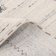 Close-up of ivory Hand Woven Loom Lori wool rug showing natural wool texture, linear detailing and fine tribal motifs