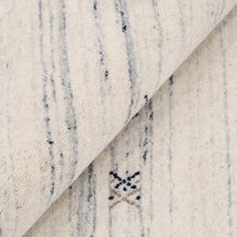 Close-up of ivory Hand Woven Loom Lori wool rug showing natural wool texture, linear detailing and fine tribal motifs