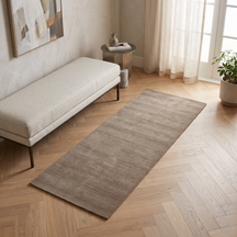 Light Beige Hand Woven Loom Lori wool rug styled in a modern interior beside a cream bench with warm wooden flooring and natural daylight.