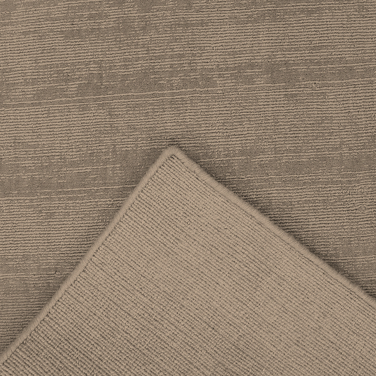 Close-up underside view of Light Beige Loom Lori runner wool rug showing the woven backing, finished edge and handcrafted construction.