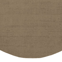 Close-up of Light Beige Round Loom Lori wool rug showing the textured woven surface and neatly finished curved edge.
