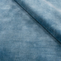 Close-up of light blue Loom Lori wool rug highlighting its soft 12-15 mm pile, smooth wool texture and subtle tonal surface variations.