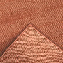 Back and edge detail of light pink Hand Woven Loom Lori wool runner rug showing its woven underside, finished border and handcrafted construction.