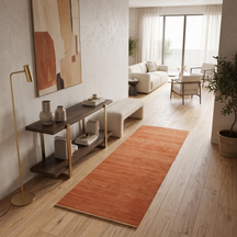 Light pink Hand Woven Loom Lori wool runner rug styled in a modern hallway with wooden flooring, neutral furniture and warm contemporary décor.