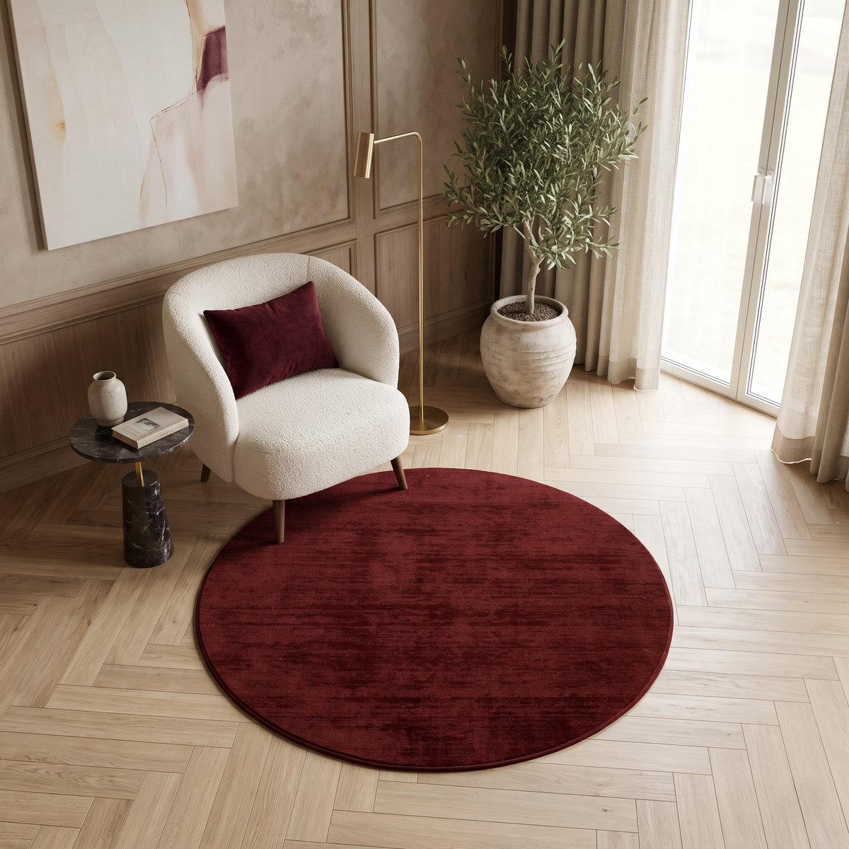 Maroon Hand Woven Loom Lori round wool rug styled in a cosy corner with an accent chair, side table and warm neutral interior.