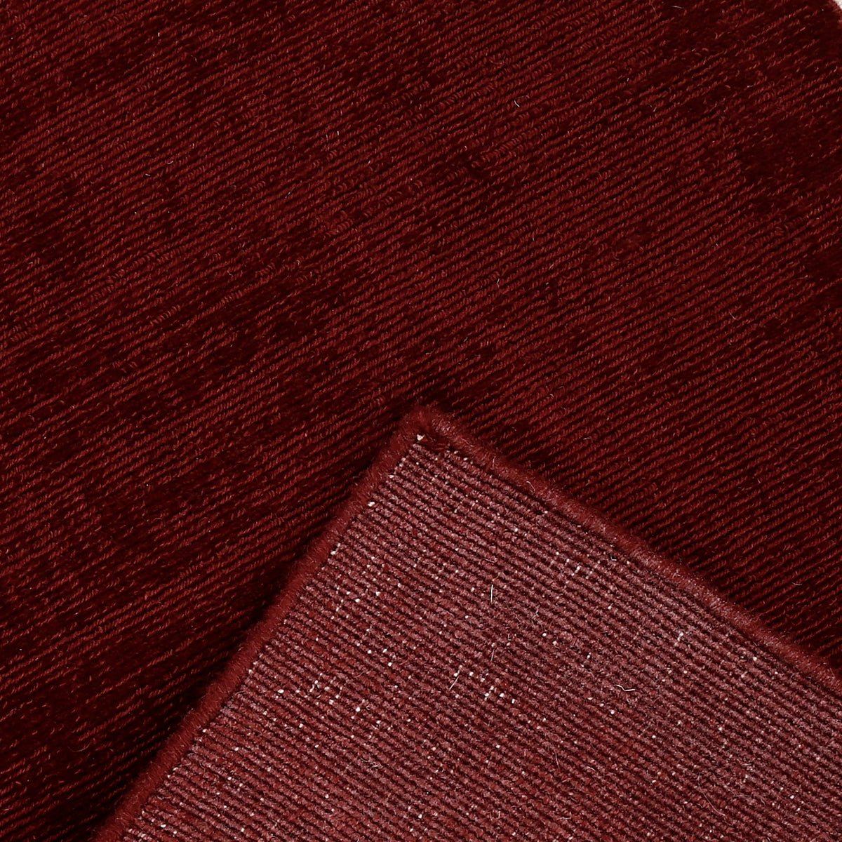 Close-up of Maroon Loom Lori runner wool rug showing the woven texture, finished edge and underside backing detail.