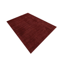 Angled view of Maroon Hand Woven Loom Lori wool rug showing its rectangular shape and subtle tonal woven texture.