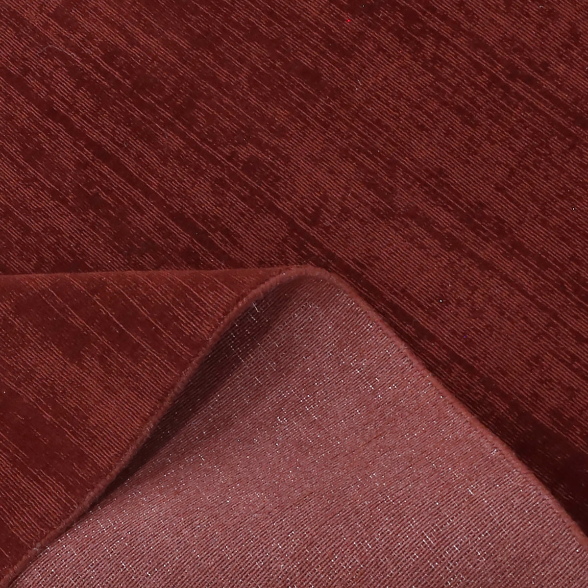 Close-up of Maroon Loom Lori wool rug showing the woven surface texture, finished edge and underside construction.