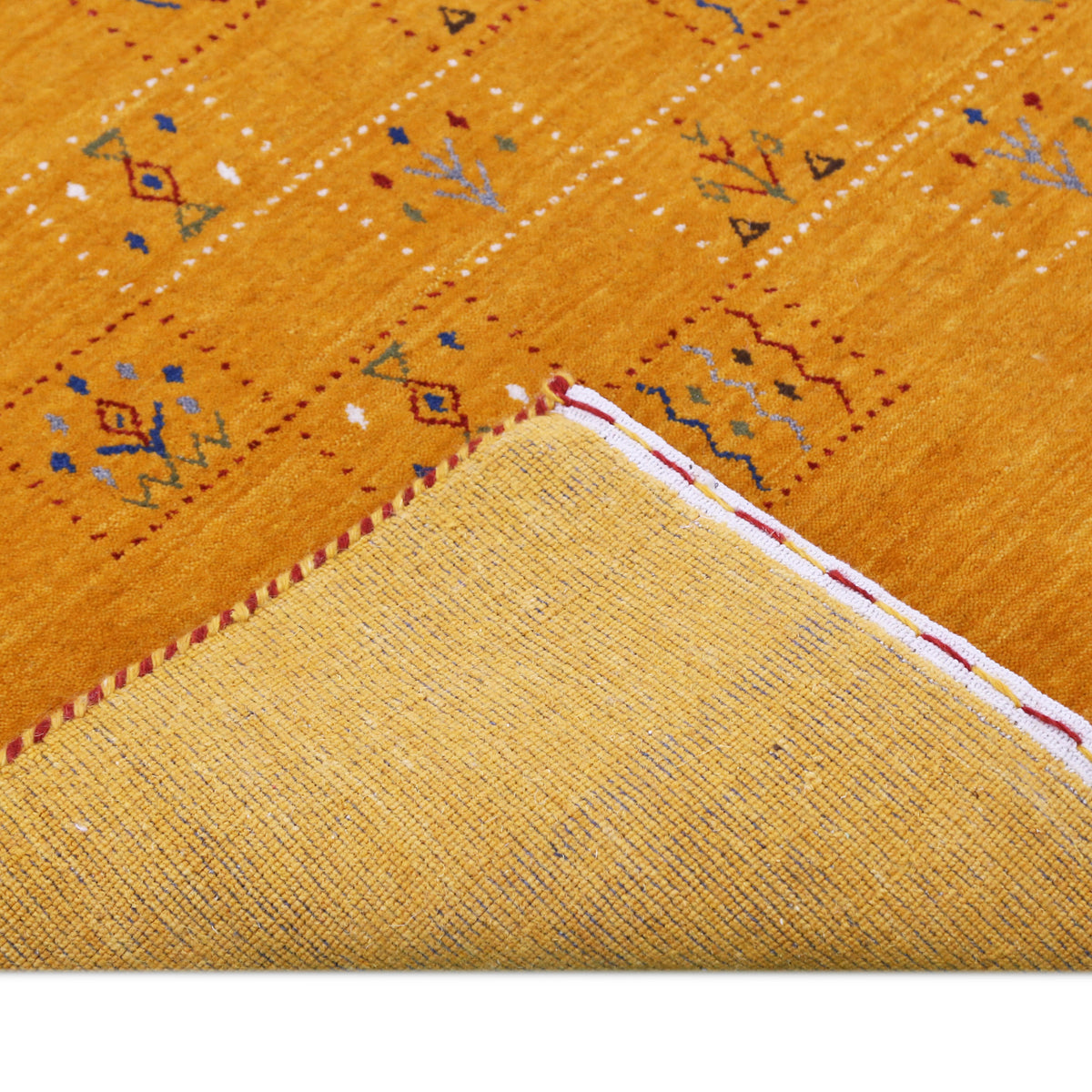 Corner and edge detail of golden mustard Hand Woven Loom Lori wool rug showing natural wool texture and handcrafted finishing