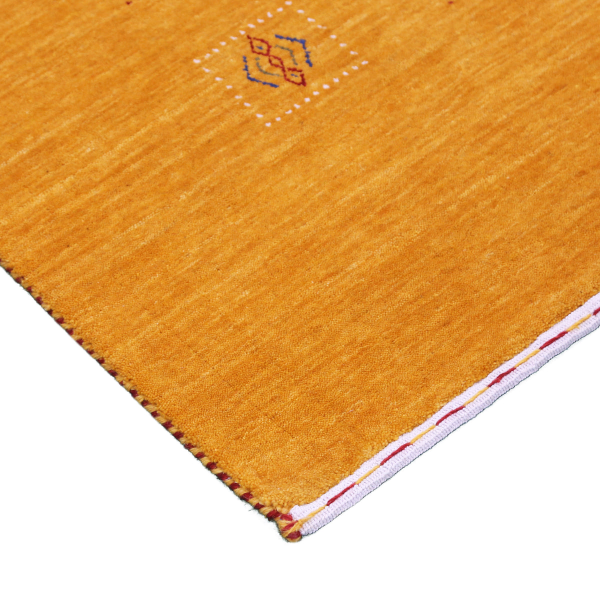 Corner and edge detail of golden mustard Hand Woven Loom Lori wool rug showing natural wool texture and handcrafted finishing