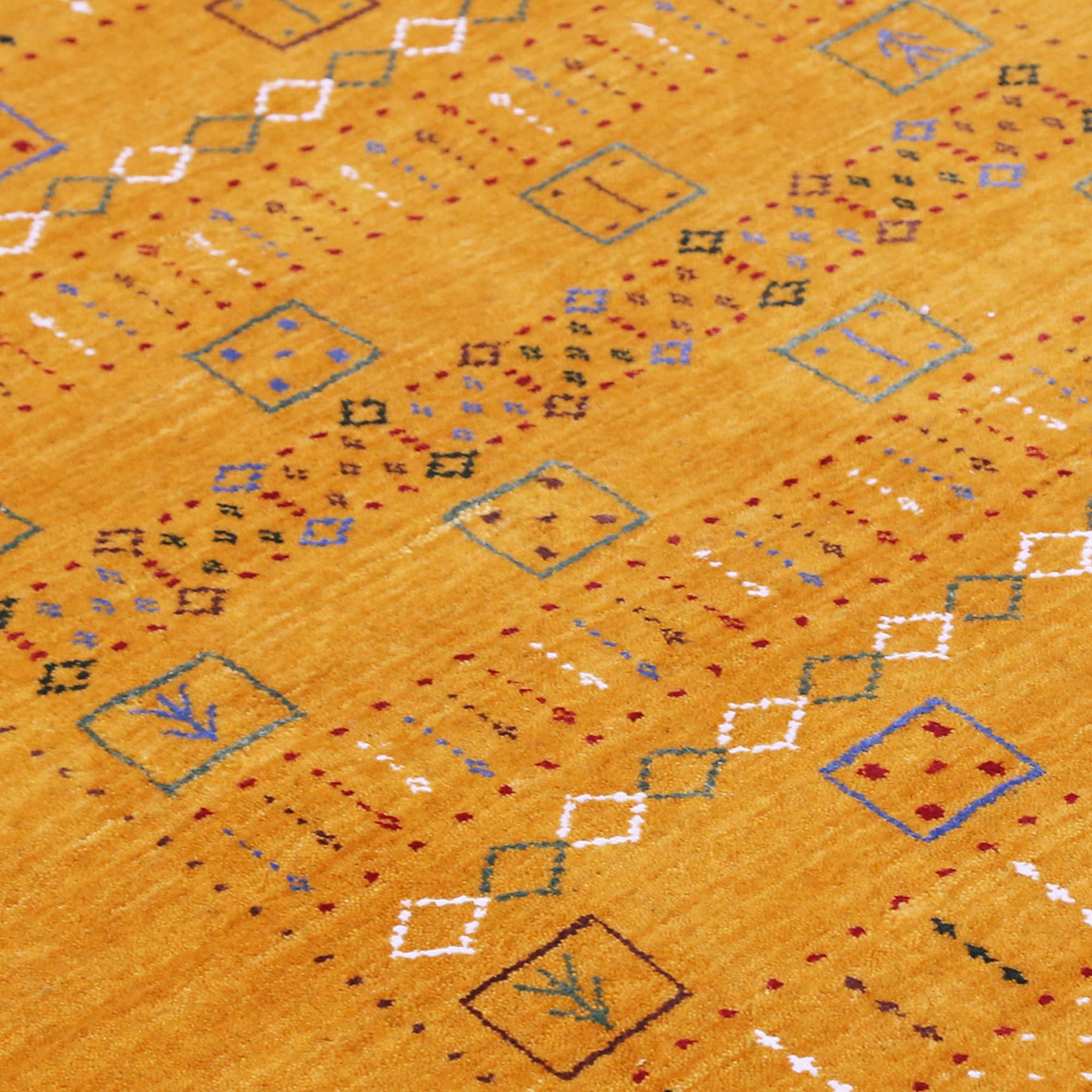 Close-up texture of mustard yellow Hand Woven Loom Lori wool rug showing natural wool fibres and intricate tribal motif detailing