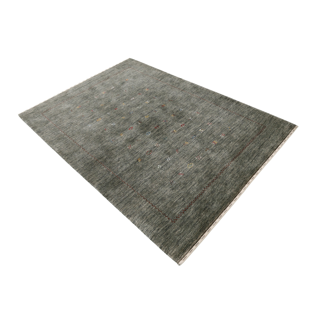 Side perspective of slate grey Hand Woven Loom Lori wool rug highlighting natural texture, scattered motifs and rust-brown zigzag border design