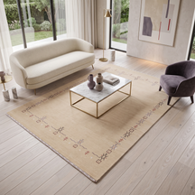 Natural beige Hand Woven Loom Lori wool rug with minimal symbolic tribal border styled in an elegant neutral living room