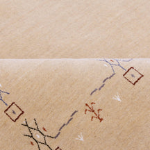 Close-up of natural beige Hand Woven Loom Lori wool rug showing natural wool texture and delicate symbolic tribal motifs
