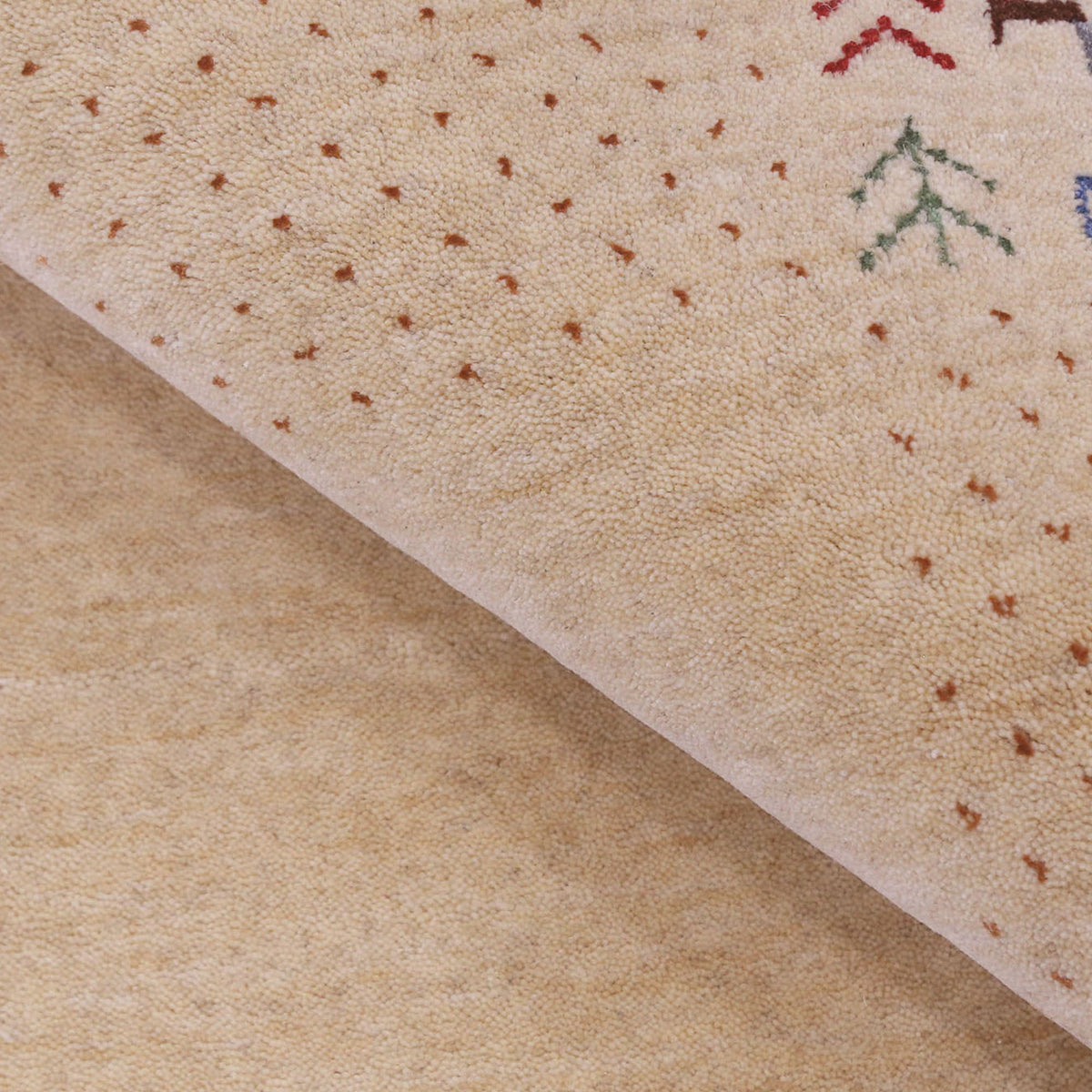 Close-up of natural beige Hand Woven Loom Lori wool rug showing natural wool texture, botanical symbols and geometric tribal motifs