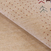 Close-up of natural beige Hand Woven Loom Lori wool rug showing natural wool texture, botanical symbols and geometric tribal motifs