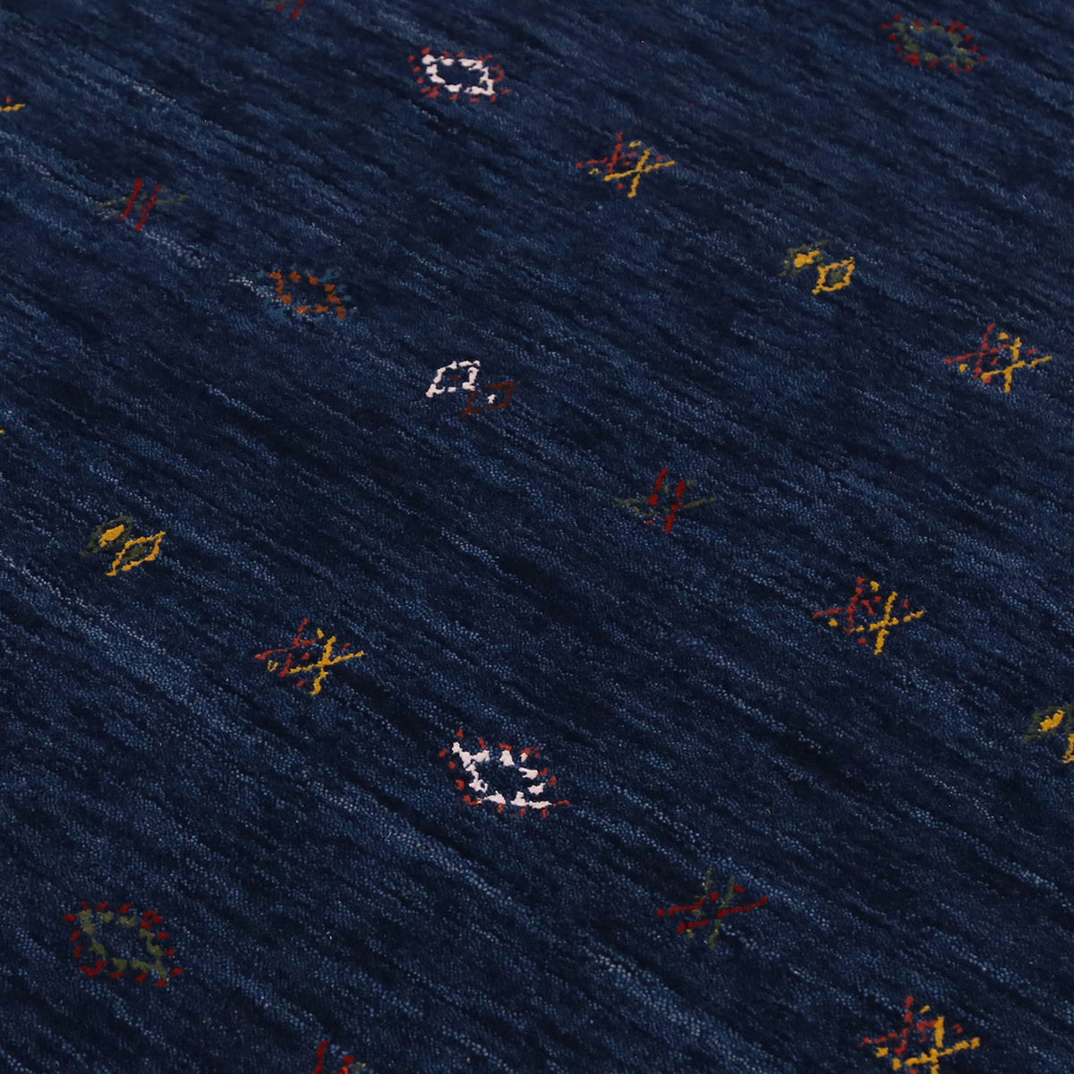 Close-up of navy blue Hand Woven Loom Lori wool rug showing natural wool texture and multicolour tribal geometric motifs
