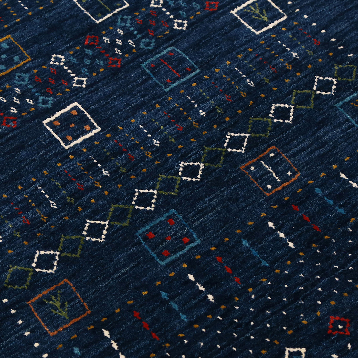 Close-up texture of navy blue Hand Woven Loom Lori wool rug showing natural wool fibres and intricate tribal motif details
