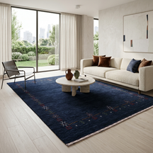 Navy blue Hand Woven Loom Lori wool rug with minimal tribal border styled in a sophisticated contemporary living room