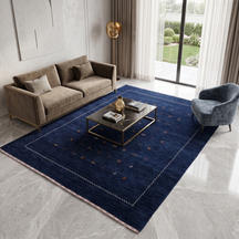 Navy blue Hand Woven Loom Lori wool rug with scattered tribal motifs and ivory zigzag border styled in an elegant living room