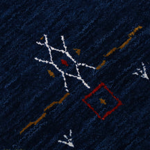Close-up of navy blue Hand Woven Loom Lori wool rug showing natural wool texture and intricate symbolic tribal detailing