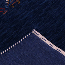 Corner and edge detail of navy Hand Woven Loom Lori wool rug showing geometric border motifs and handcrafted finishing