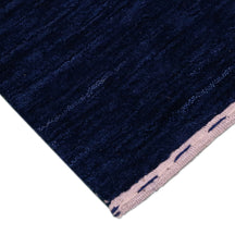 Corner and edge detail of navy Hand Woven Loom Lori wool rug showing geometric border motifs and handcrafted finishing