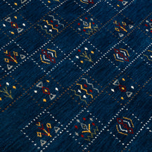 Close-up of deep navy blue Hand Woven Loom Lori wool rug showing dotted grid panels and multicolour tribal motifs