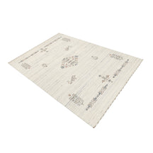 Side perspective of ivory cream Hand Woven Loom Lori wool rug highlighting handcrafted texture and central tribal medallion design