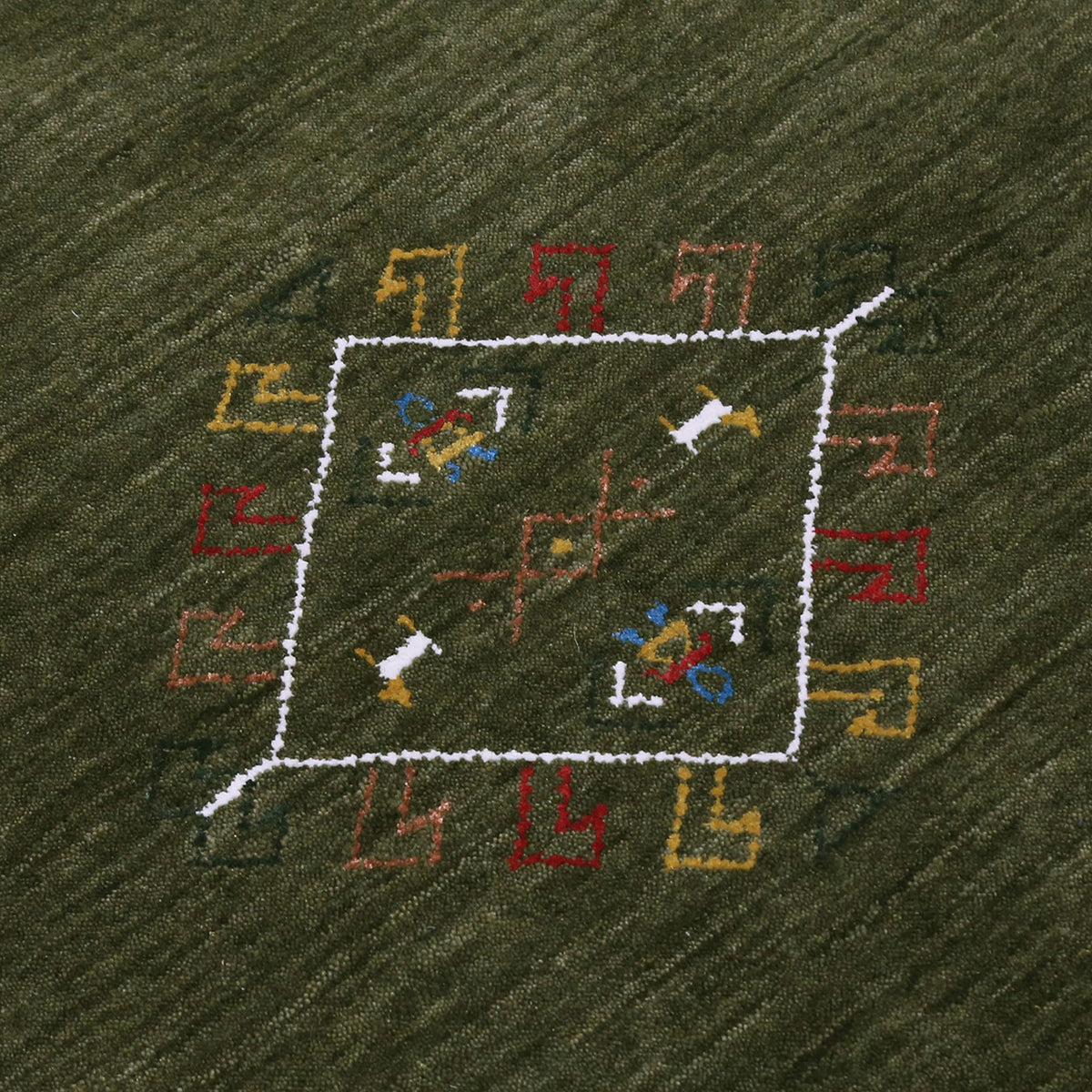 Close-up of olive green Hand Woven Loom Lori wool rug showing central diamond motif, colourful folk details and natural wool texture