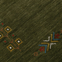 Close-up of olive green Hand Woven Loom Lori wool rug showing central diamond motif, colourful folk details and natural wool texture
