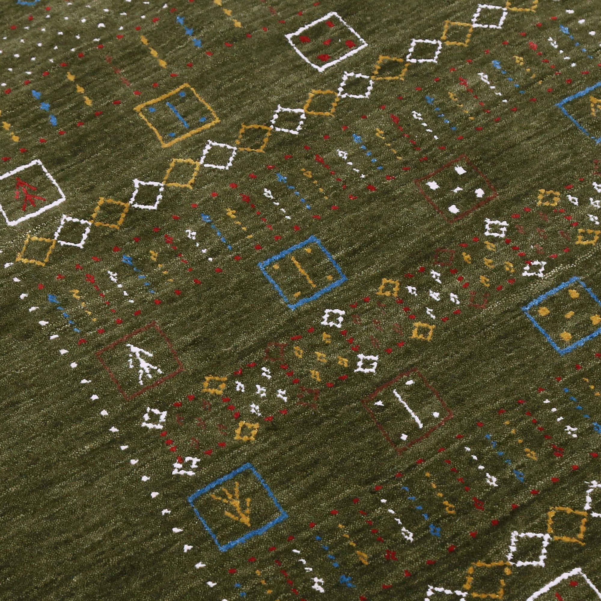 Close-up texture of Hand Woven Loom Lori wool rug showing olive green wool fibres and multicolour geometric motifs